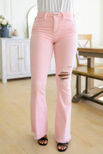 Feminine Flair Mid Rise Distressed Flares in Pastel Pink