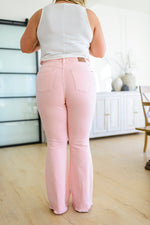 Feminine Flair Mid Rise Distressed Flares in Pastel Pink